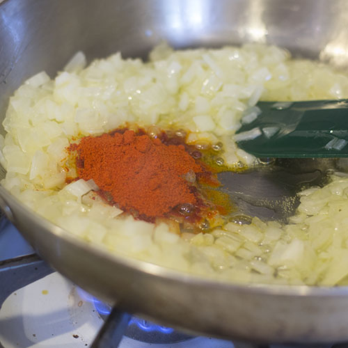 Sweet Paprika Added to Onions