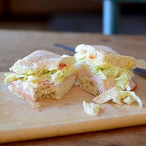 Turkey Slaw Sriracha Sandwich Split bite out closer 500