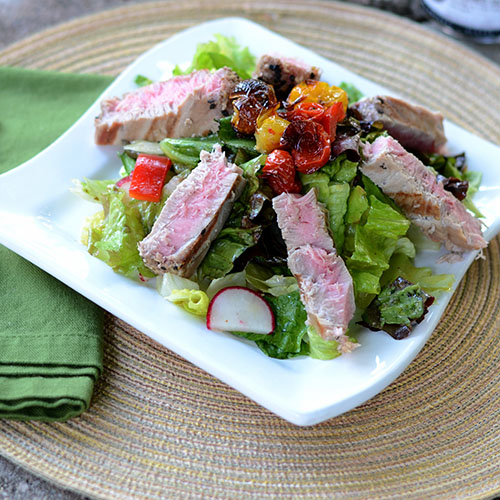 Seared-Tuna-on-a-Bed-of-Greens tuna, salad, vegetables, healthy, roasted, tomatoes, peppers, radishes