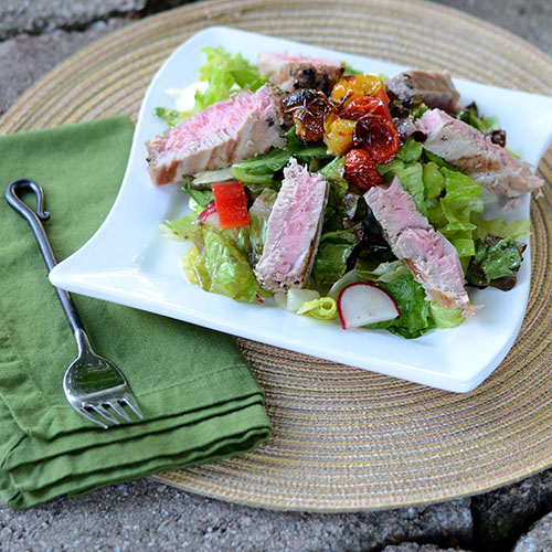 Seared-Tuna-on-a-Bed-of-Greens tuna, salad, vegetables, healthy, roasted, tomatoes, peppers, radishes