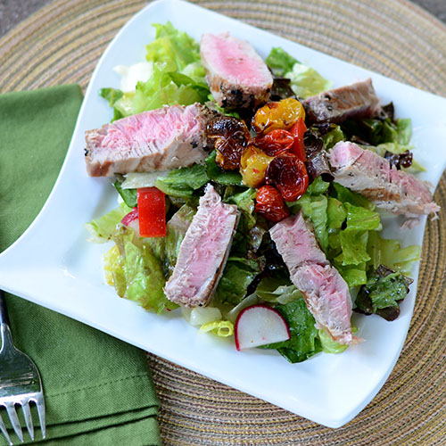 Seared-Tuna-on-a-Bed-of-Greens tuna, salad, vegetables, healthy, roasted, tomatoes, peppers, radishes