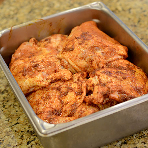 paste-added-to-chicken Paste on chicken, canola oil, orange juice, achiote, cumin, garlic, adobo, oregano, cayenne, red pepper flakes, chicken, peppers,