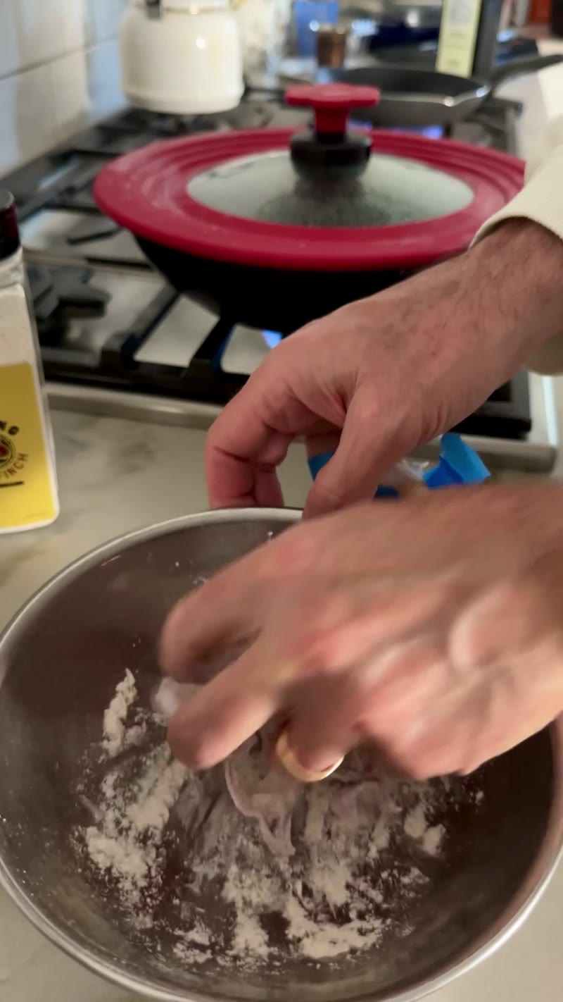 Tossing shallot rings in gluten-free breading