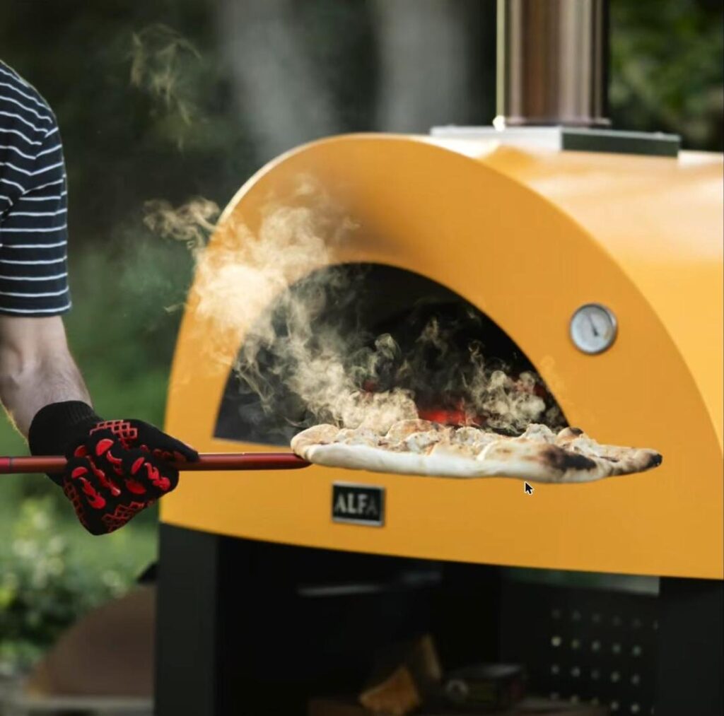 Pulling a steaming wood-fired pizza out of the Alfa oven